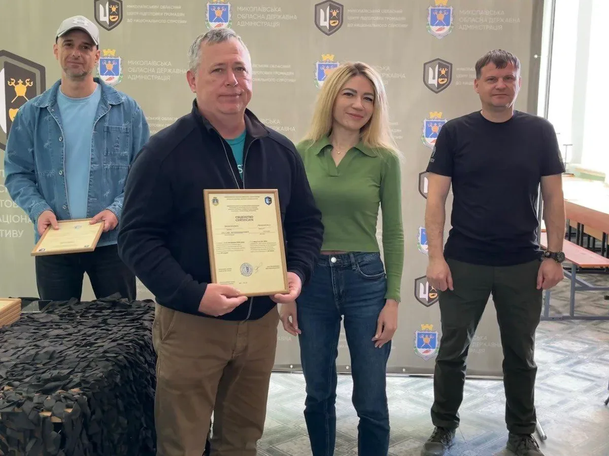 Група людей у військовій формі отримує сертифікати про завершення військового вишколу. 3