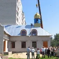 Герб Української Православної Церкви Київського Патріархату на тлі розмитого зображення міста Херсон 2