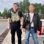 Співробітник міграційної поліції супроводжує іноземця до контрольно-пропускного пункту на кордоні