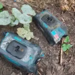 Пакування вологих серветок, в якому заховано вибуховий пристрій, на фоні пошкодженої ділянки землі.