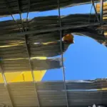 Пошкоджена АЗС у Херсоні після атаки російського дрона, біля якої стоять поранені працівники