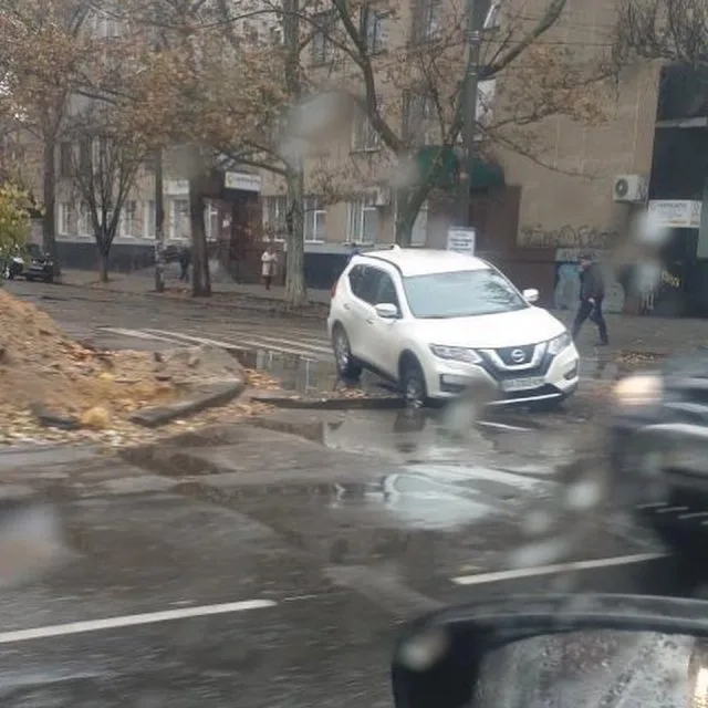 В центре Херсона внедорожник провалился в яму на проезжей части